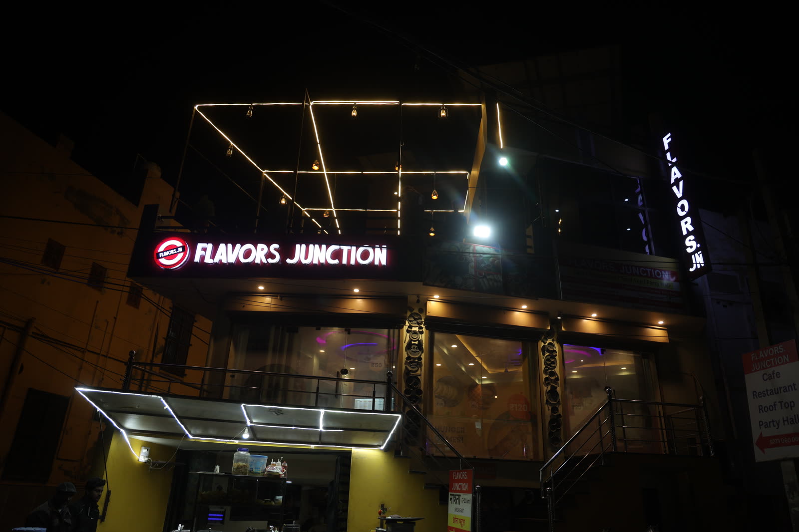 Flavors Junction storefront lit up at night